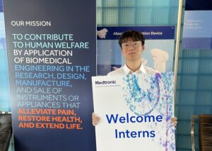 Allen holding a "welcome interns" sign.